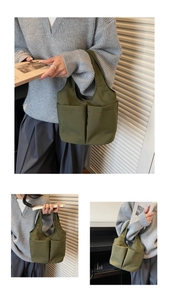 Détail du sac fourre-tout en nylon vert olive avec double poche frontale fonctionnelle