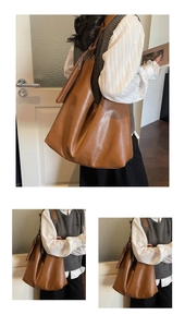 Detail view of large brown faux leather tote bag with soft texture and matching mini pouch