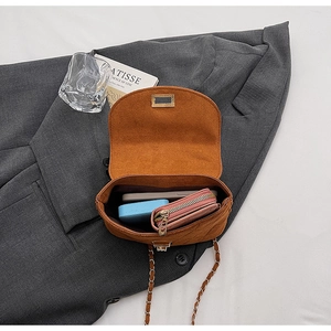 Internal view of brown corduroy saddle bag showing smartphone and wallet storage
