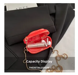 Detail view of the interior capacity showing a lipstick inside the orange marble acrylic bag