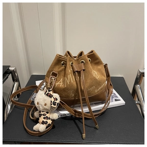 Brown frosted bucket bag with custom typography and cute kitty plush doll accessory