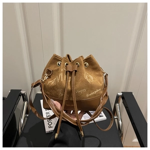 Close-up of brown plush drawstring bucket bag with Happy Everyday printed text
