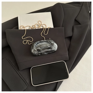 Artistic marble pattern evening clutch with gold chain strap and rounded oval shape