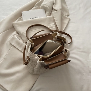 Chic sherpa fleece bucket bag with brown leather trim shown in a stylish flat lay layout
