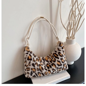Detail view of plush leopard print hobo bag with contrast knot strap and gold metal hardware
