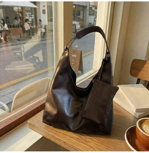 Deep brown vintage PU leather tote bag in a cozy cafe setting with matching coin purse