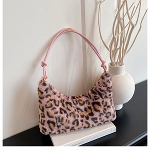 Detail of pink leopard print faux fur bag with soft texture and leather handle