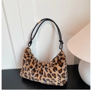 Detail of plush leopard print shoulder bag featuring soft texture and knot strap details