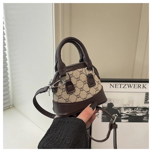 Detail of mini monogram shell bag with dark brown leather trim and silver metal zipper