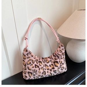 Detail of pink faux fur shoulder bag with leopard print and knotted leather handle