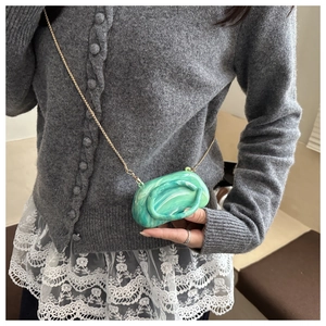 Mini crossbody bag featuring green marble texture and a slender gold chain strap