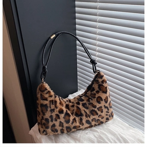 Macro detail of plush faux fur texture and leopard print on this large hobo shoulder bag