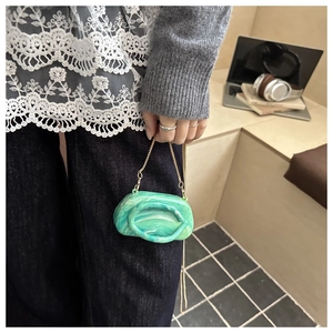Detail of green marble acrylic mini cloud clutch bag with gold chain strap