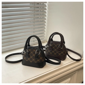 Detail of mini shell bags in black and coffee canvas with leather handles and straps