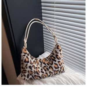 Close-up of leopard print faux fur hobo bag with white woven rope strap and gold hardware