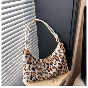 Detailed close-up of leopard faux fur texture and white woven rope handle of hobo bag