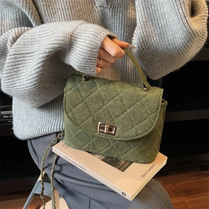 Elegant dark green quilted handbag with gold chain strap and metal turn-lock closure