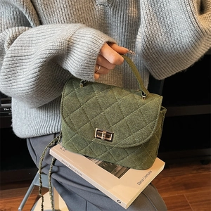 Quilted dark green chain handbag with gold twist lock and wool-like texture