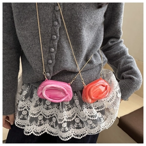 Mini marble textured crossbody bag with pink and orange patterns and a gold chain