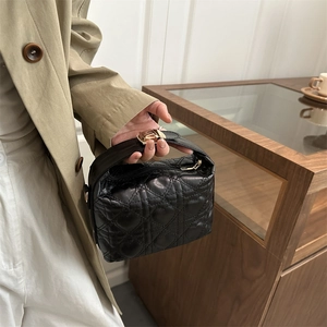 Chic black heart-quilted leather handbag with gold clasp handle for women's fashion