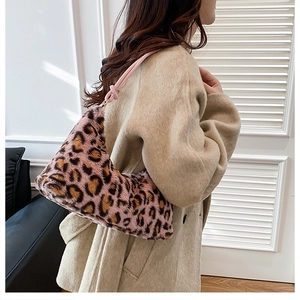 Detailed view of pink leopard faux fur tote with soft texture and knotted strap design