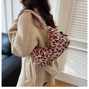 Side view of pink leopard print faux fur shoulder bag with knotted strap detail