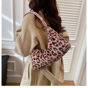 Detail of pink leopard faux fur tote bag with knotted shoulder strap and plush texture