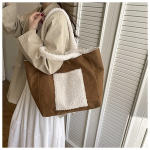 Detail of faux shearling trim and brown suede material on large shoulder tote bag