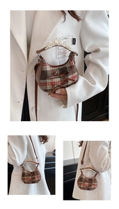 Detail of red-brown plaid moon bag with bow decoration and delicate lace handle