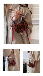 Macro detail of leopard print mini bag with red bows and lace handle on a shoulder strap