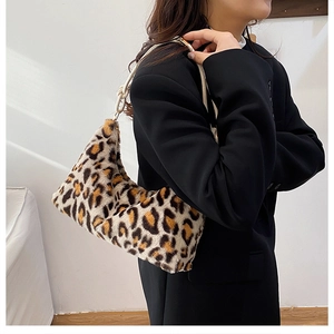 Detail of plush leopard print tote bag with white woven rope shoulder strap and gold hardware