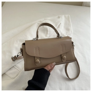 Detailed view of vintage brown PU leather crossbody bag with flap and decorative buttons
