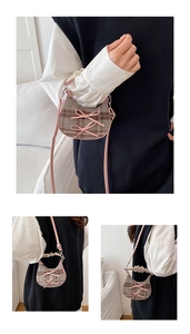Close-up of mini plaid crossbody bag with pink bow accents and lace trim details