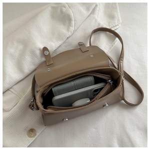 Internal view of khaki crossbody bag showing storage capacity for phone and wallet