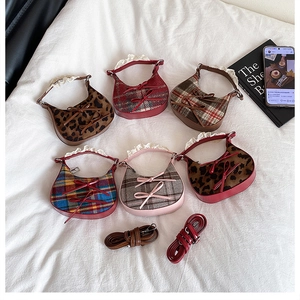Detail of mini hobo bags featuring assorted patterns, bows, and lace lace-trimmed handles
