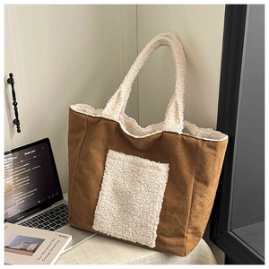 Close-up of brown suede tote bag featuring white lamb wool pocket and soft texture