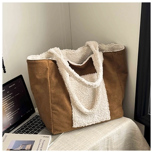Detail of plush lamb wool lining and brown corduroy texture on winter tote bag
