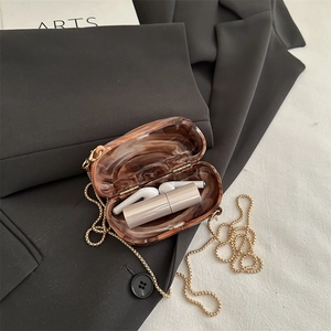 Mini amber marble acrylic clutch bag with gold chain and handle in vintage luxury style
