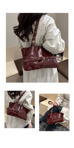 Detail view of burgundy wax leather hobo bag with glossy finish and metal buckles