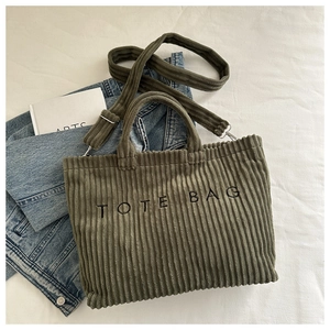 Détail du sac fourre-tout en velours côtelé vert olive avec broderie et bandoulière