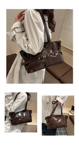 Detail view of dark brown oil wax leather tote bag with stylish buckle strap and eyelets
