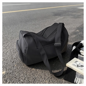 Detail of waterproof nylon travel bag showing shoe compartment and adjustable shoulder strap