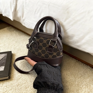 Retro vintage brown shell handbag with textured pattern and adjustable shoulder strap