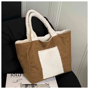 Detail of winter brown velvet tote bag with white faux shearling trim and front pocket