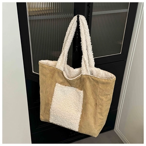 Detail of khaki corduroy tote bag with white plush fleece handles and front pocket trim