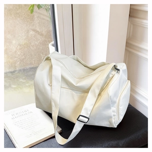 Close-up of white waterproof fitness bag showing zipper detail and nylon texture