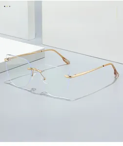 Detail of pink gold metal temples and rimless geometric cat-eye lenses on display