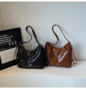 Detail view of vintage tote bags in black and brown faux leather with tassel accents