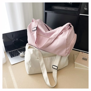 Pink and cream large fitness bags showing waterproof nylon texture and adjustable straps