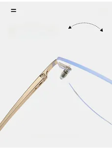Detail of durable gold spring hinge on rimless cat eye glasses with blue tinted lenses